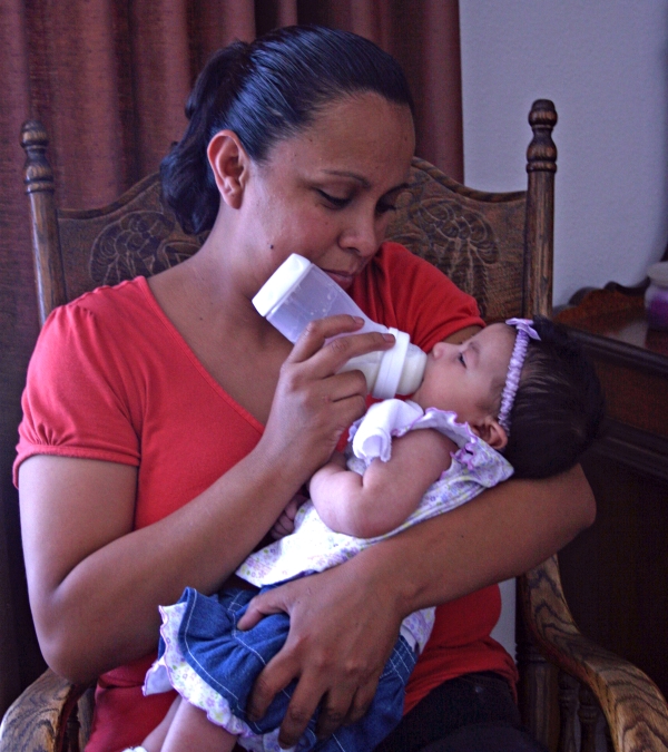 Mother feeding baby with bottle