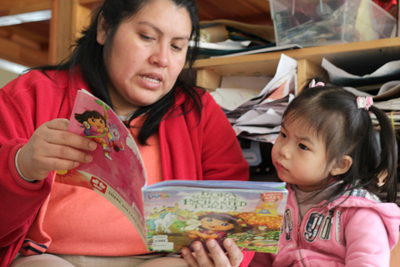 Mother reading book to daughter