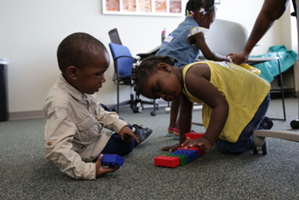 Toddler boy and girl playing with blocks