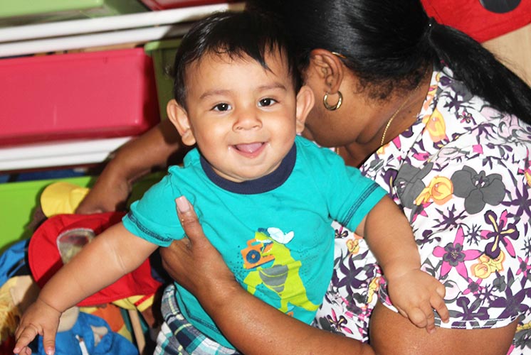 a toddler boy smiles at the camera