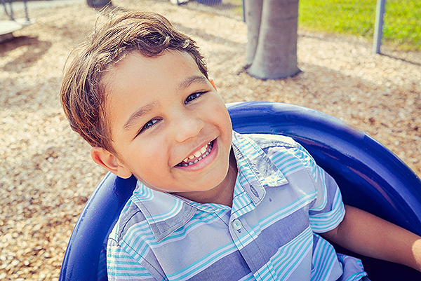 Young boy playing on playground equipment