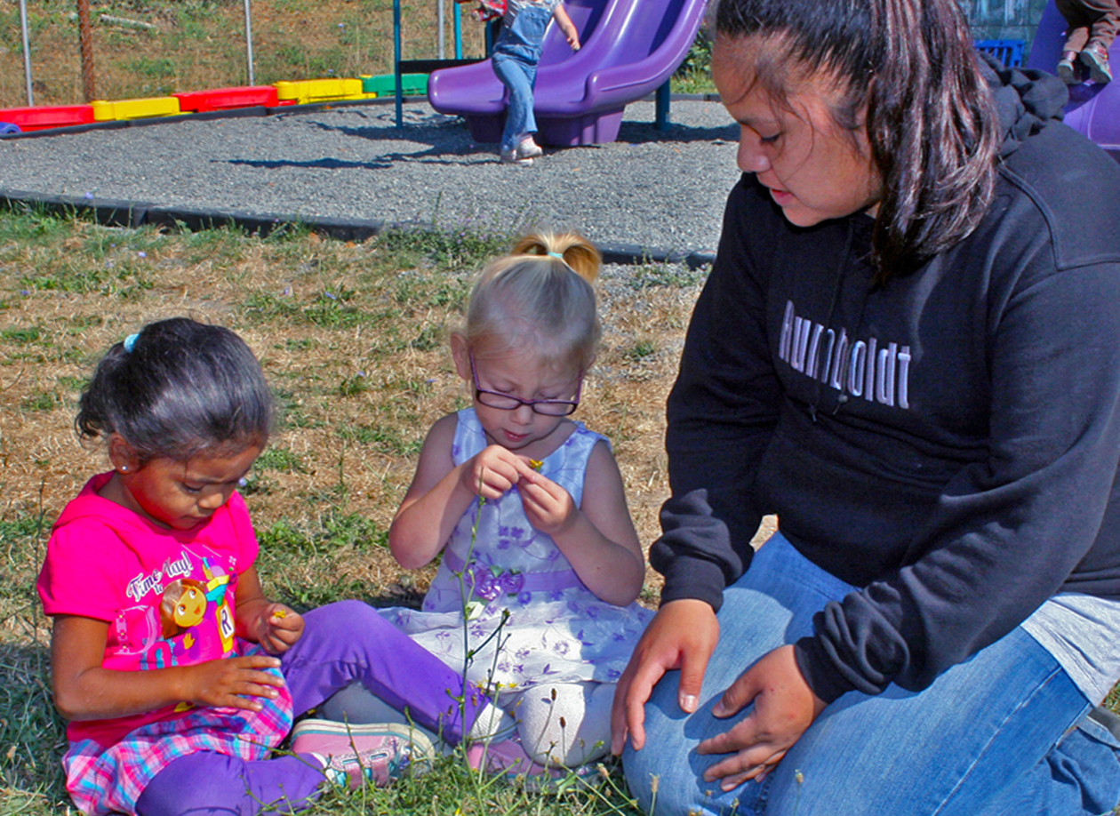 Teacher with kids near a playground