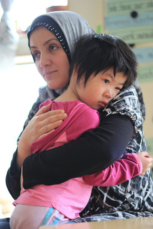 Woman holding crying girl