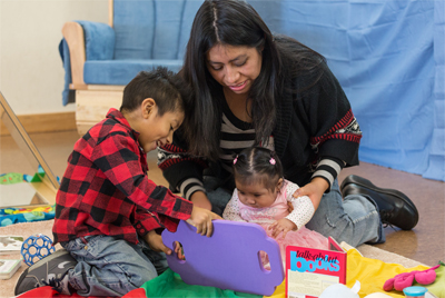 Woman playing with two kids