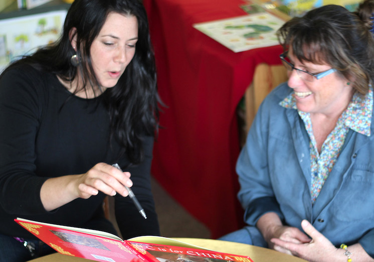 Woman pointing at a page in a book