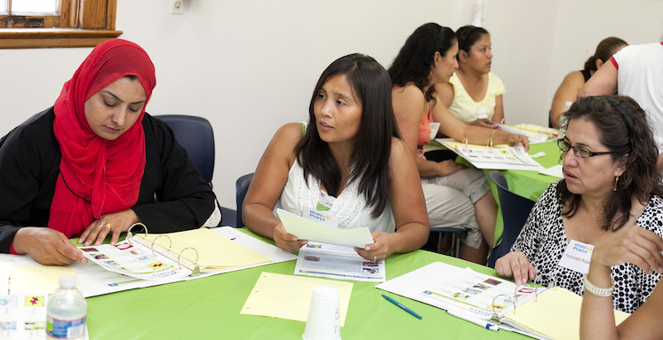 Women sitting around a table talking and discussing